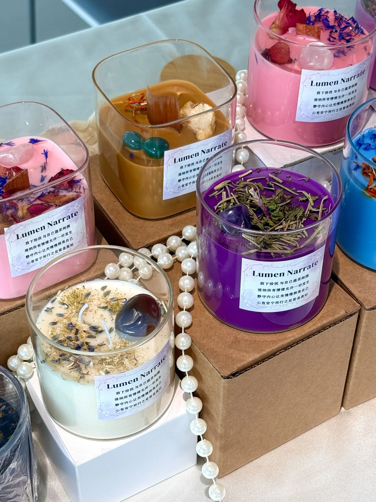 Color-led wellness-inspired candle collection with botanical and crystal-inspired details
