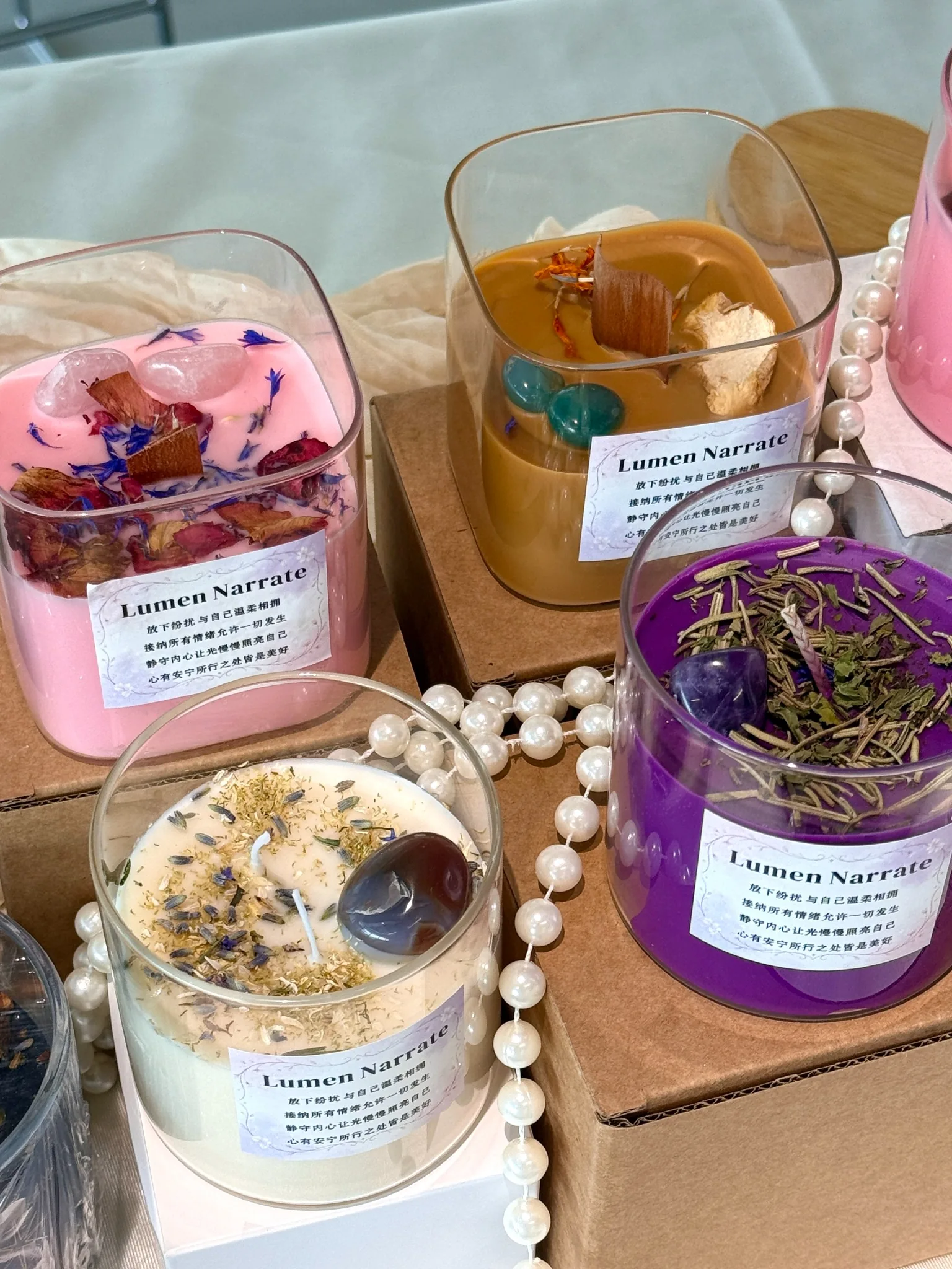 Gift-ready wellness-inspired candle sets with multiple colors and botanical details