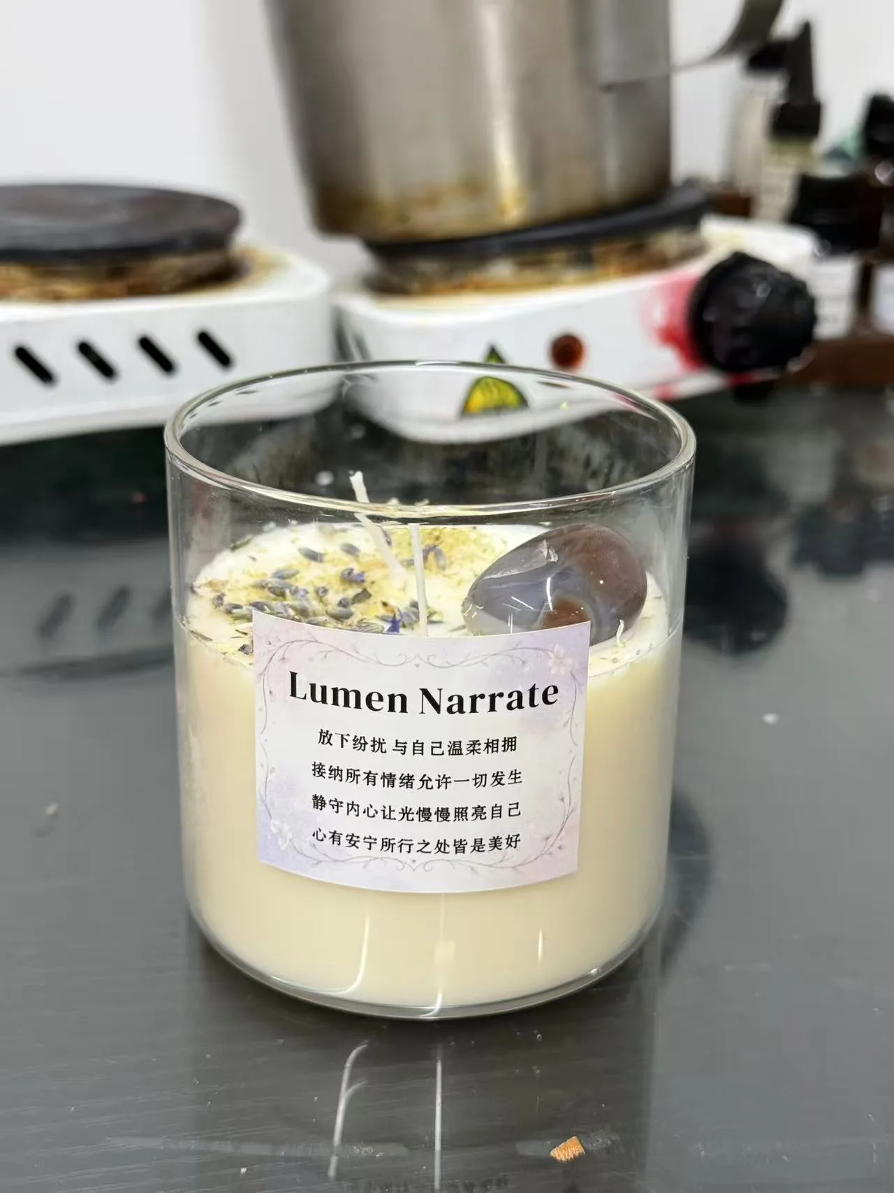 Small batch wellness-inspired candle sample with botanical and stone details in development setting