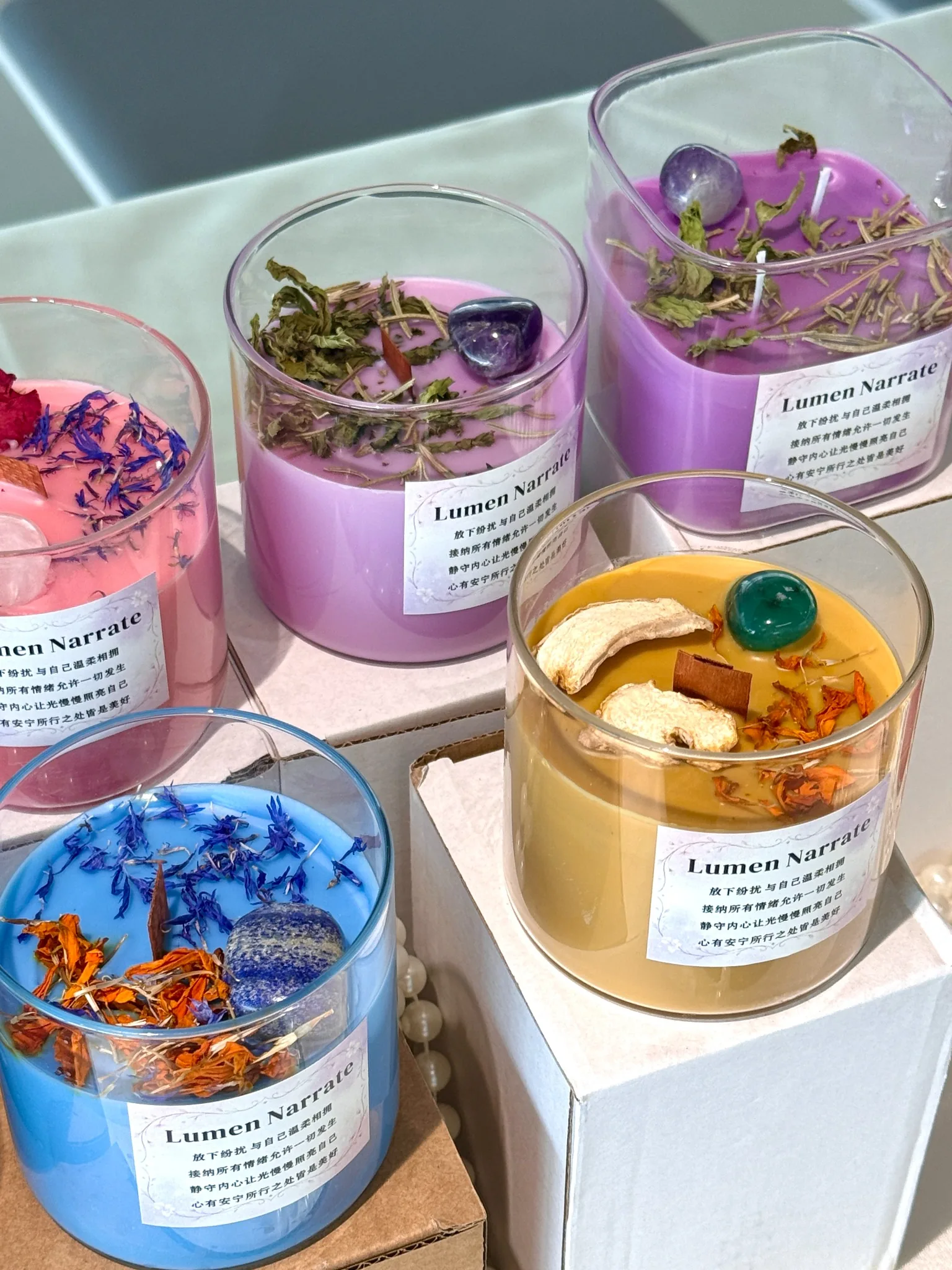 Wellness-inspired candles arranged on boxes for wholesale and brand display